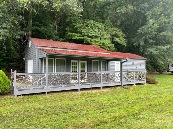 a front view of house with outdoor seating yard and green space
