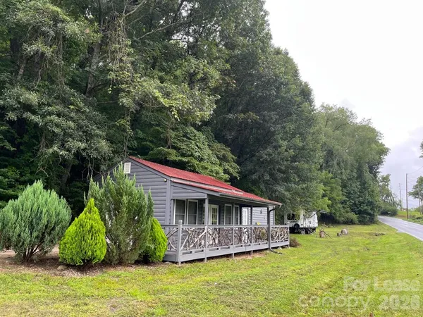a backyard of a house with yard table and chairs