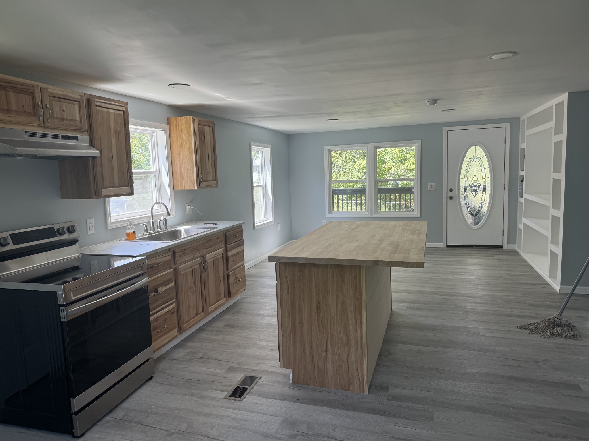 499 Carter Blake Road Tullahoma, TN 37388 - Photo 1 of 15 a kitchen with stainless steel appliances granite countertop a stove a sink dishwasher and microwave with wooden floor