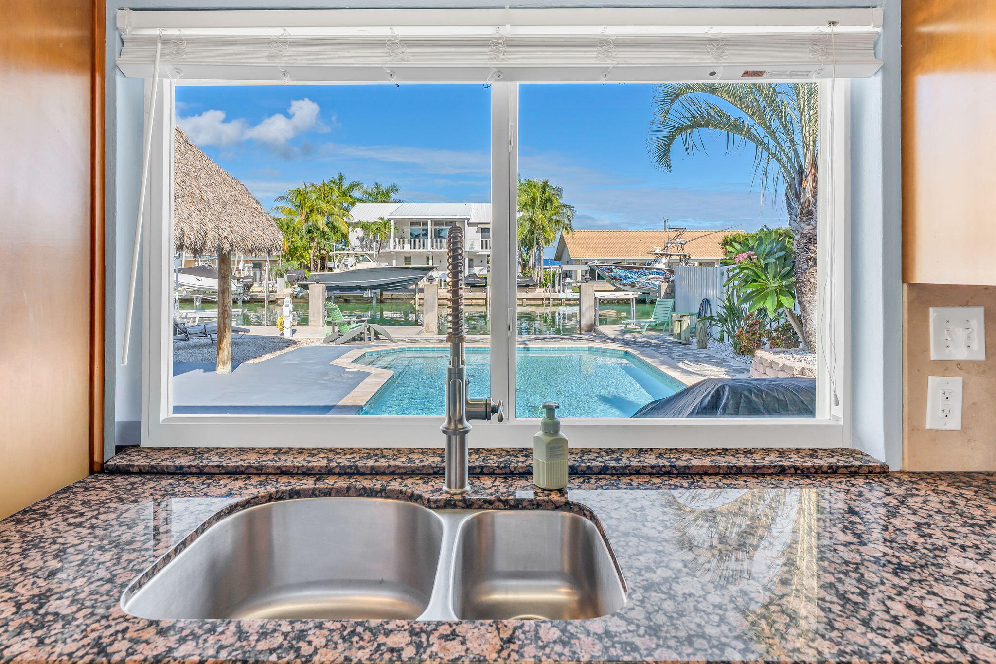 600 12th Street Key Colony Beach, FL 33051 - Photo 12 of 40 a bathroom with a granite countertop sink and a mirror