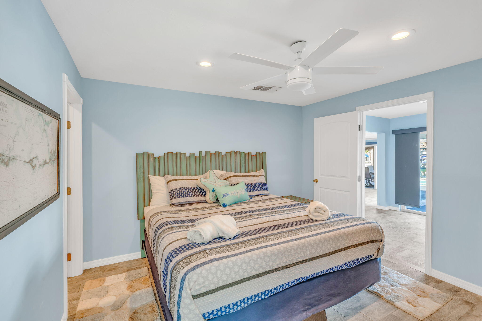 600 12th Street Key Colony Beach, FL 33051 - Photo 17 of 40 a bedroom with a large bed and a chandelier