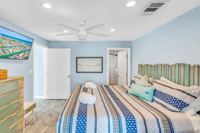 a bedroom with a bed and a painting on the wall