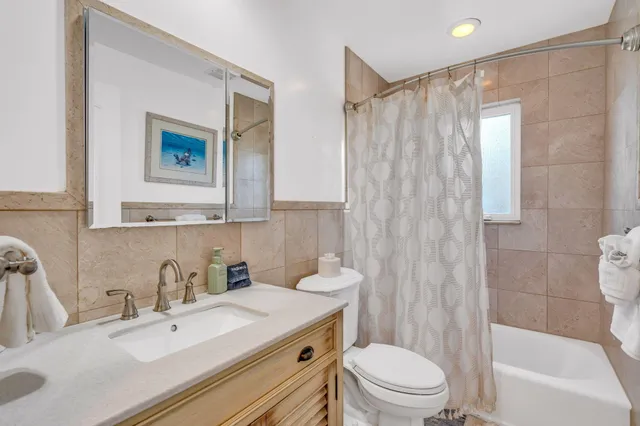 a bathroom with a sink a toilet and shower curtain