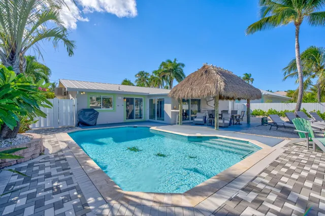 a view of house with swimming pool outdoor seating