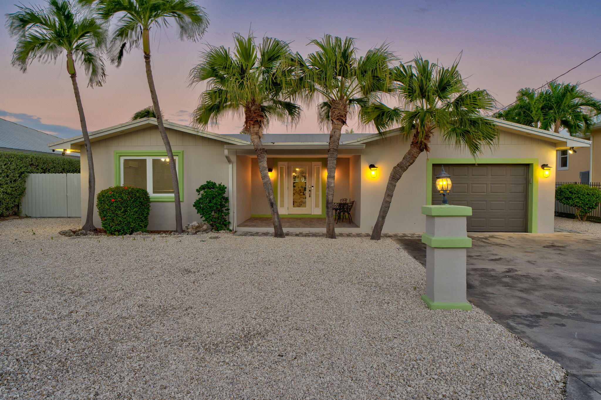 600 12th Street Key Colony Beach, FL 33051 - Photo 5 of 40 a front view of a house with a yard and garage