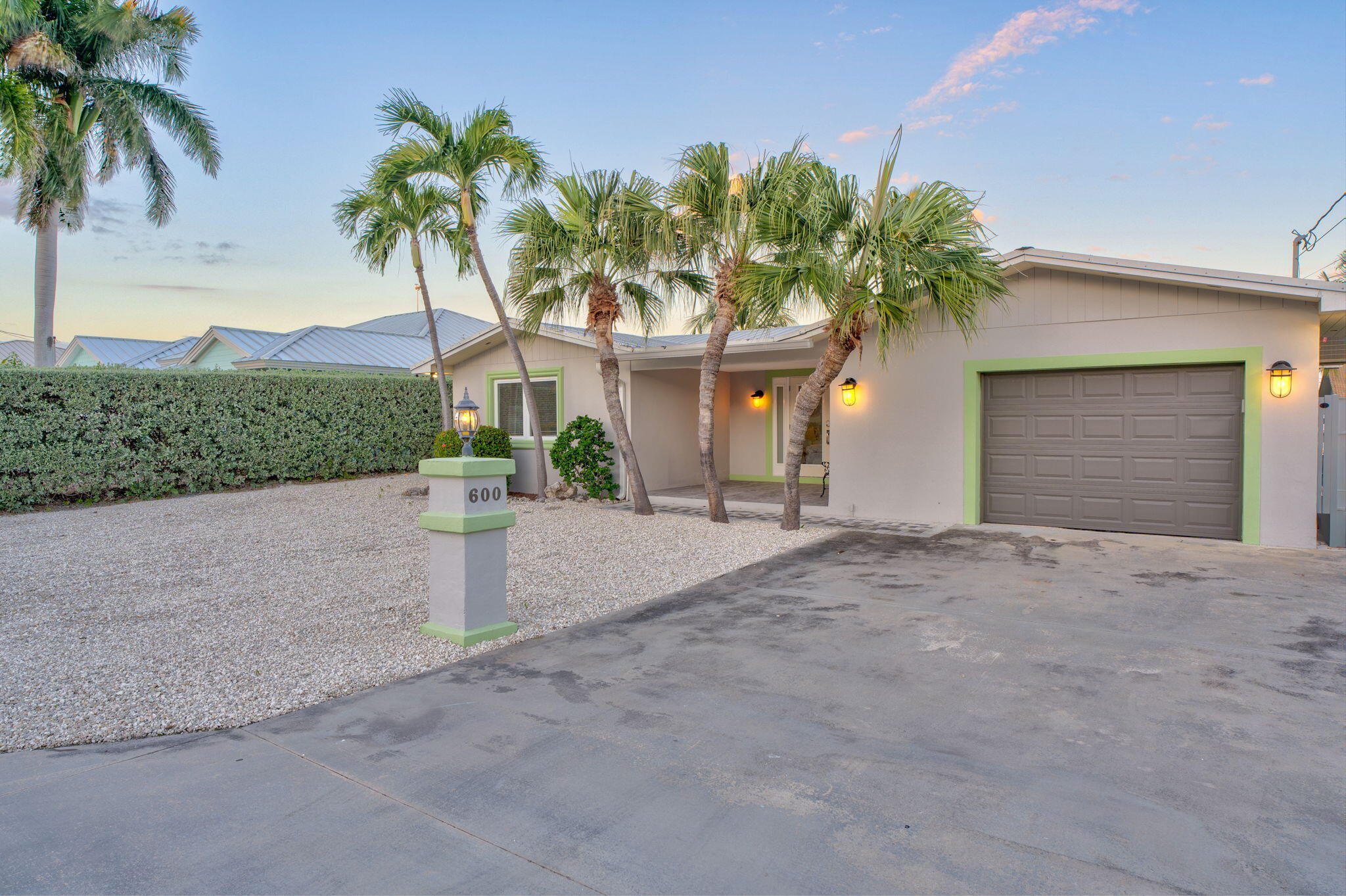 600 12th Street Key Colony Beach, FL 33051 - Photo 6 of 40 a view of a house with a yard and palm trees