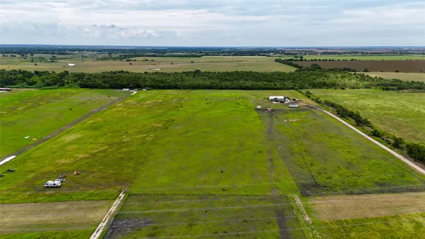a view of a field with an ocean view