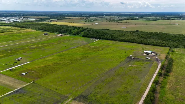 a view of a field with an ocean view