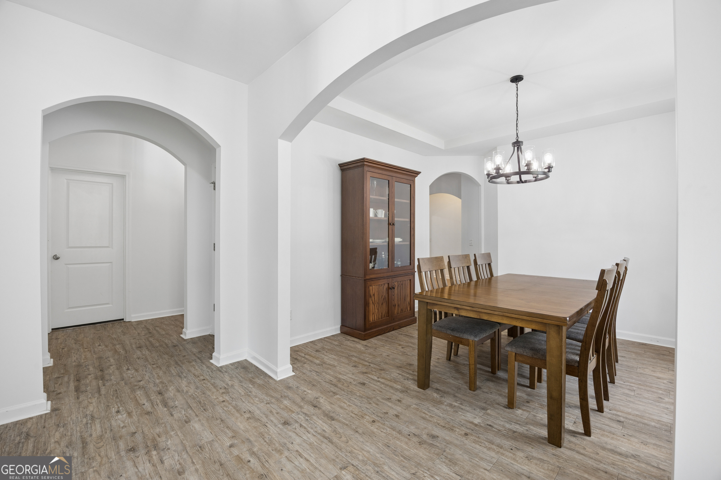 369 Waybridge Way Richmond Hill, GA 31324 - Photo 22 of 40 a view of a dining room with furniture and wooden floor