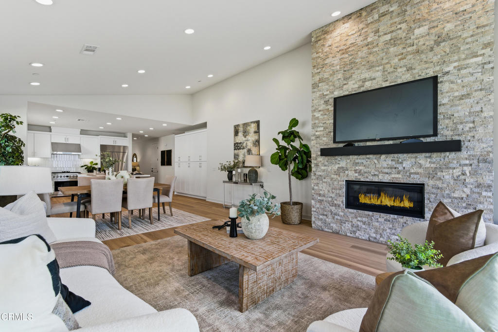 3245 Arrowhead Court Altadena, CA 91001 - Photo 11 of 37 a living room with furniture a flat screen tv and a fireplace