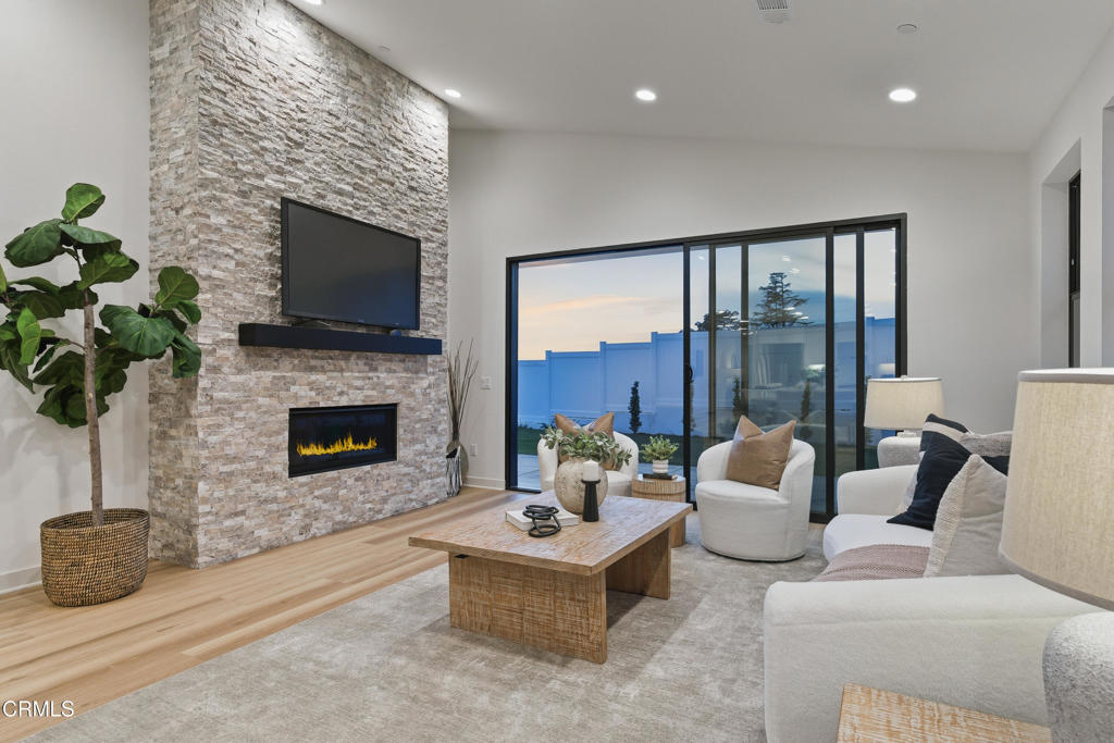 3245 Arrowhead Court Altadena, CA 91001 - Photo 12 of 37 a living room with furniture a fireplace and a flat screen tv