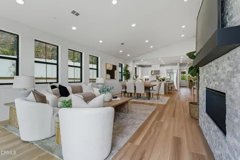 a living room with furniture a fireplace and a flat screen tv