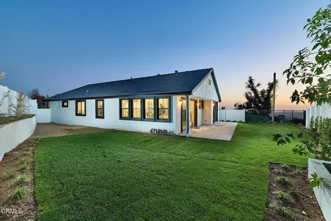 a view of a house with a yard and a porch