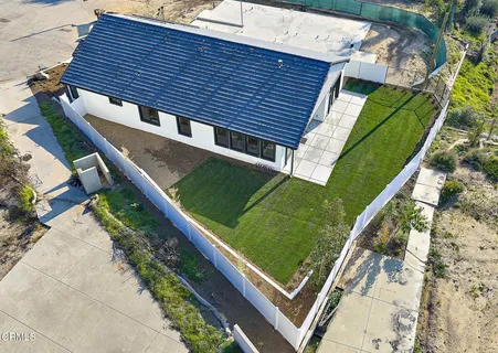 a view of a backyard with sitting area