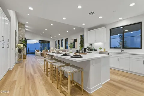 a kitchen with stainless steel appliances kitchen island granite countertop a sink and cabinets