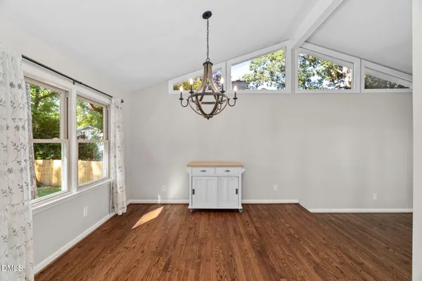 a bathroom with a toilet a sink a mirror and vanity