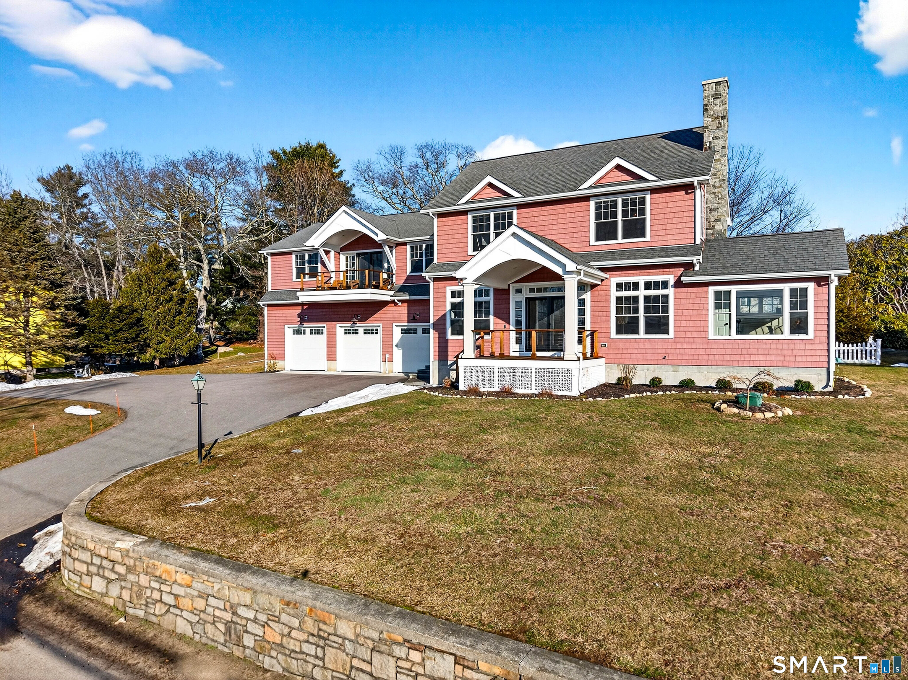 77 Masons Island Road Stonington, CT 06355 - Photo 1 of 35 a front view of a house with a yard