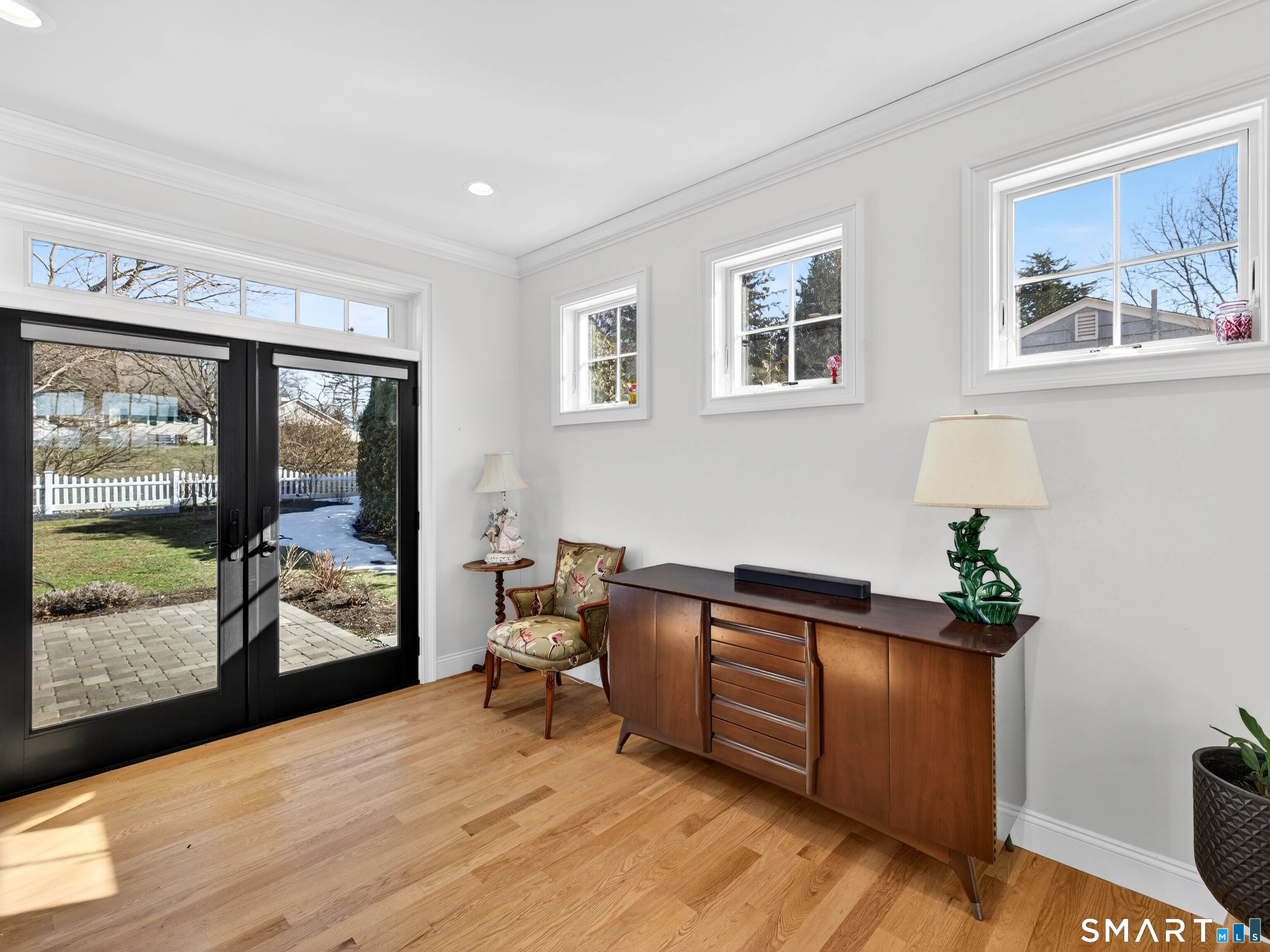 77 Masons Island Road Stonington, CT 06355 - Photo 14 of 35 a living room with furniture and large windows