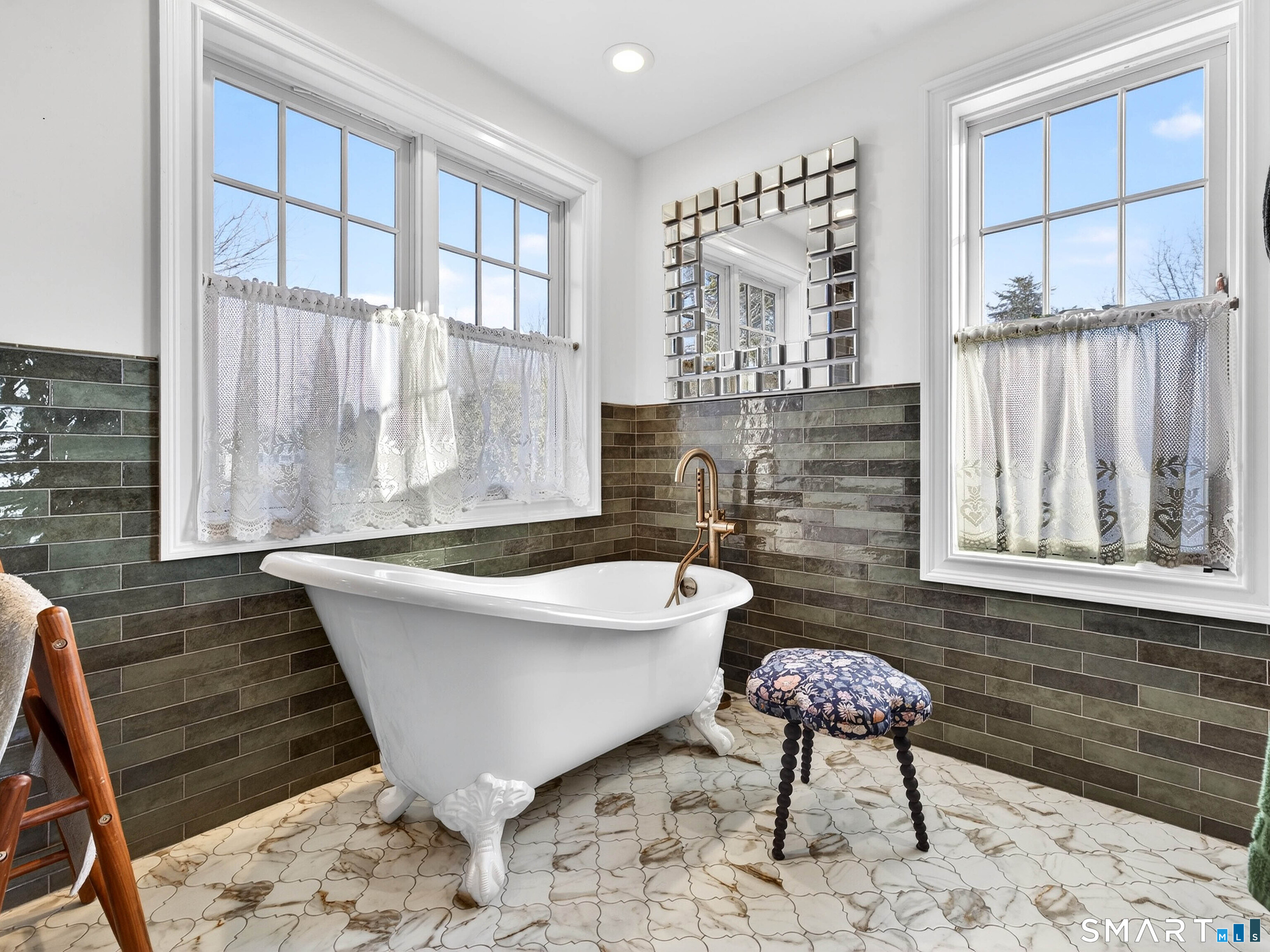 77 Masons Island Road Stonington, CT 06355 - Photo 19 of 35 a spacious bathroom with a bathtub and window