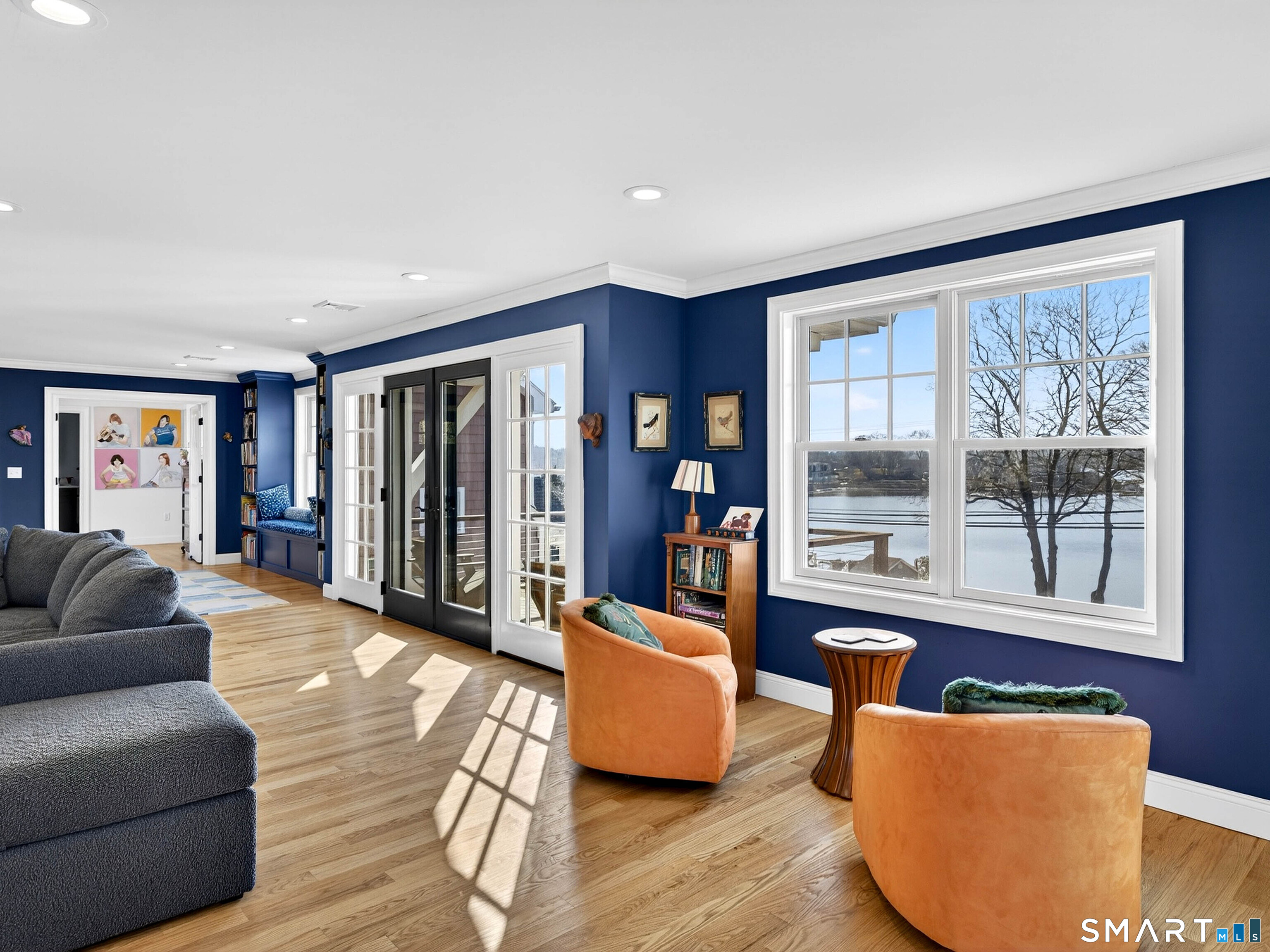 77 Masons Island Road Stonington, CT 06355 - Photo 22 of 35 a living room with furniture and large window with wooden floor