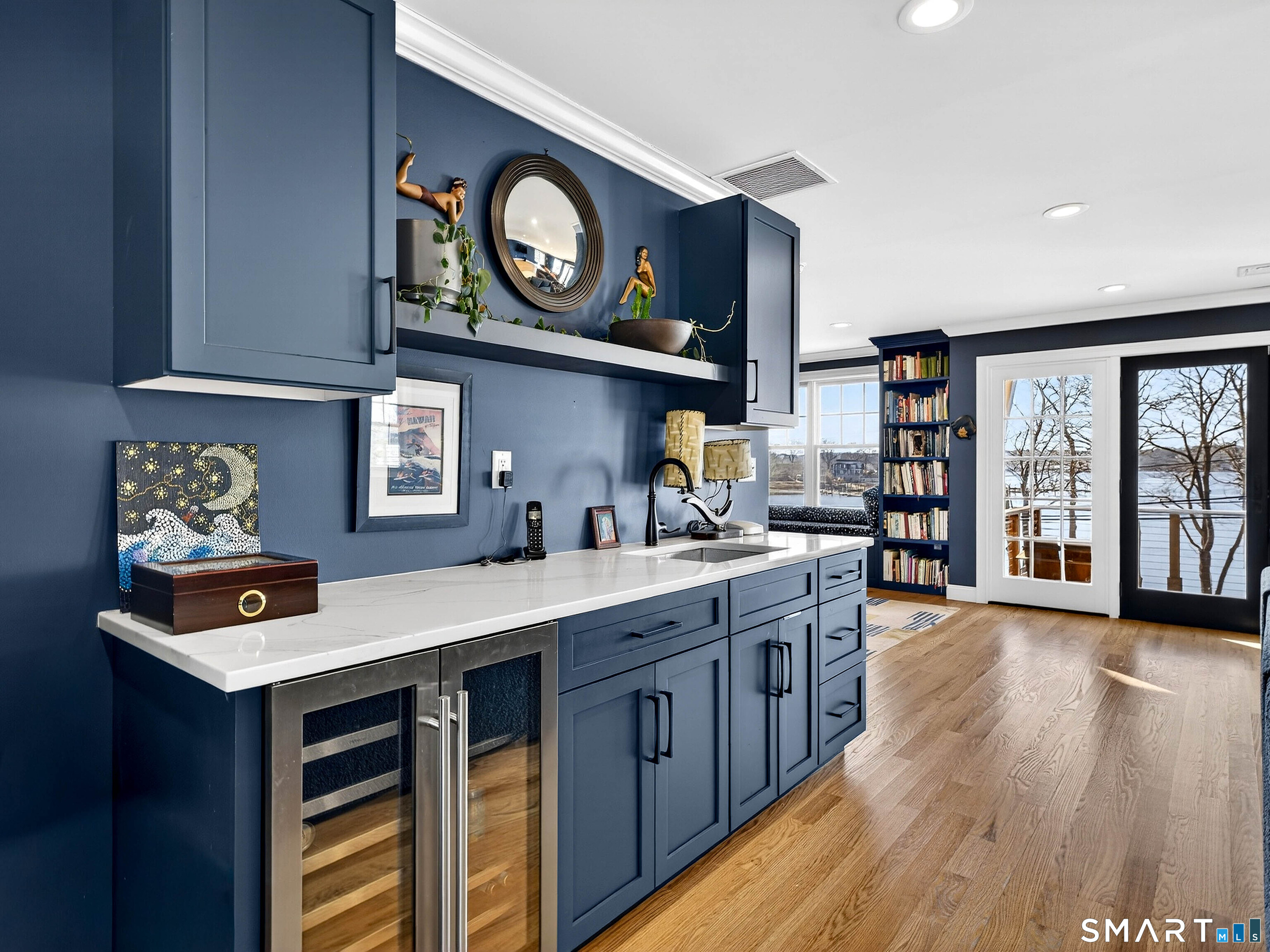 77 Masons Island Road Stonington, CT 06355 - Photo 24 of 35 a kitchen with stainless steel appliances granite countertop a stove a sink and a microwave with wooden floor