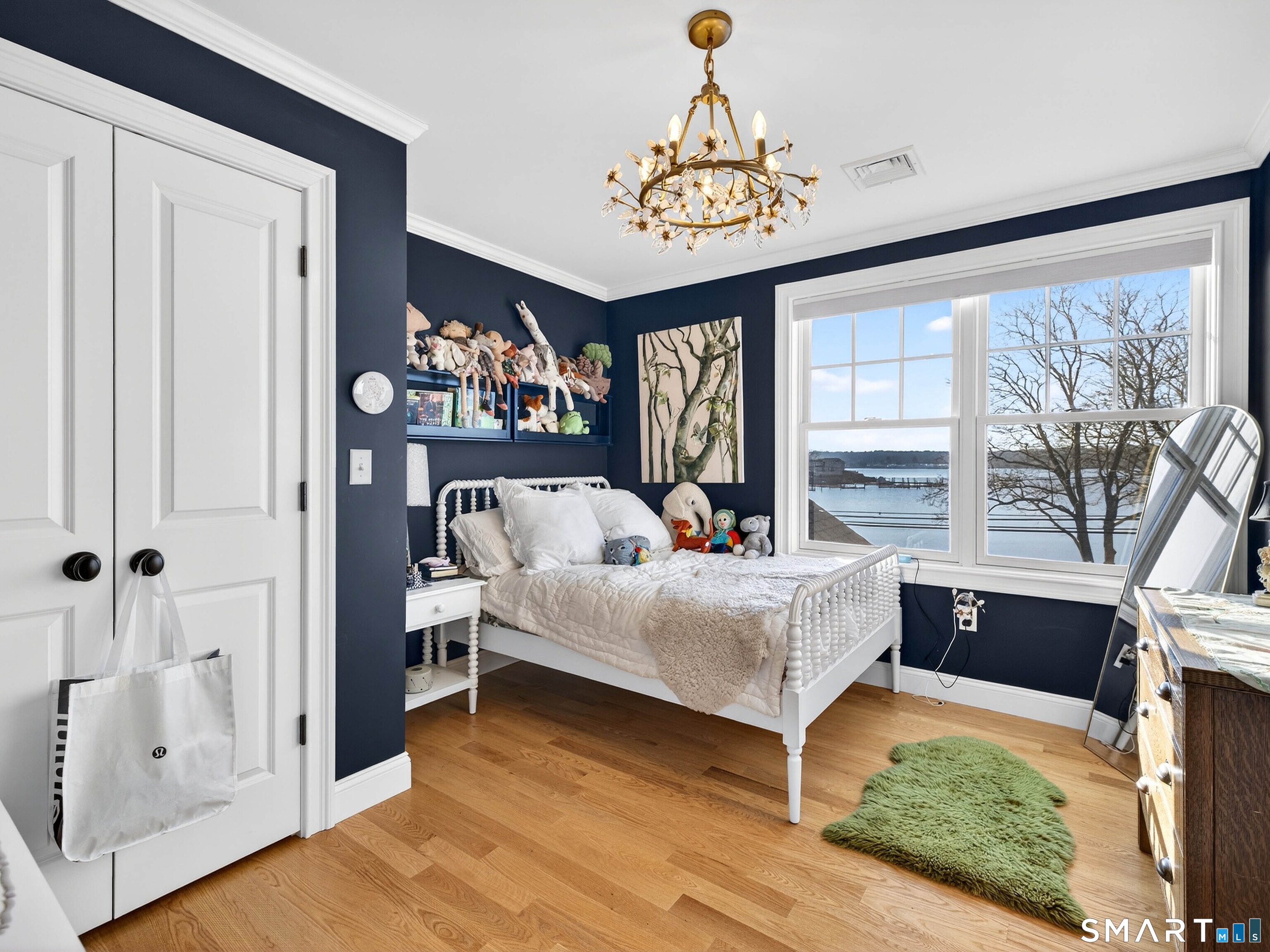 77 Masons Island Road Stonington, CT 06355 - Photo 26 of 35 a living room with furniture and a chandelier