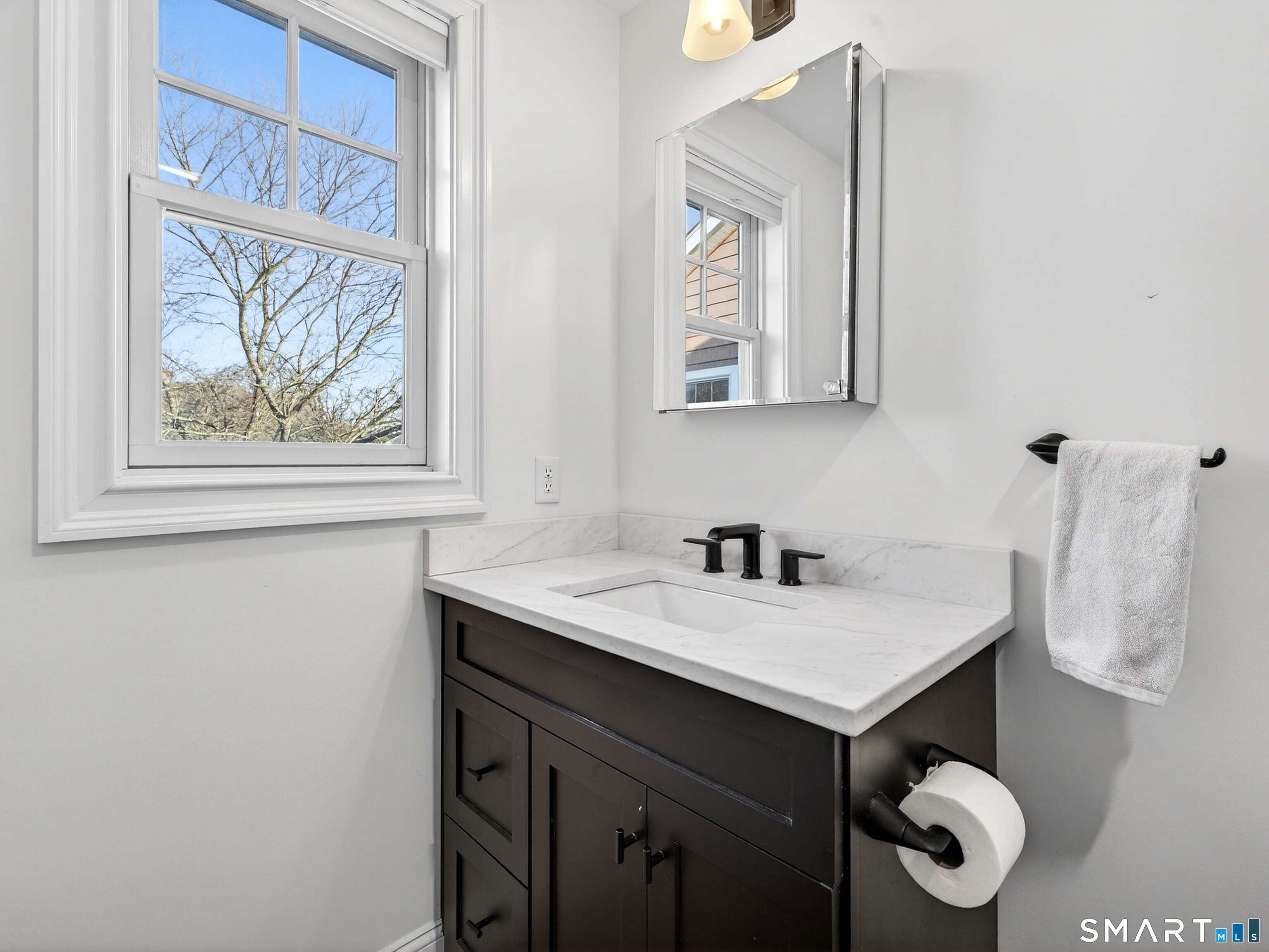 77 Masons Island Road Stonington, CT 06355 - Photo 29 of 35 a bathroom with a sink and a mirror