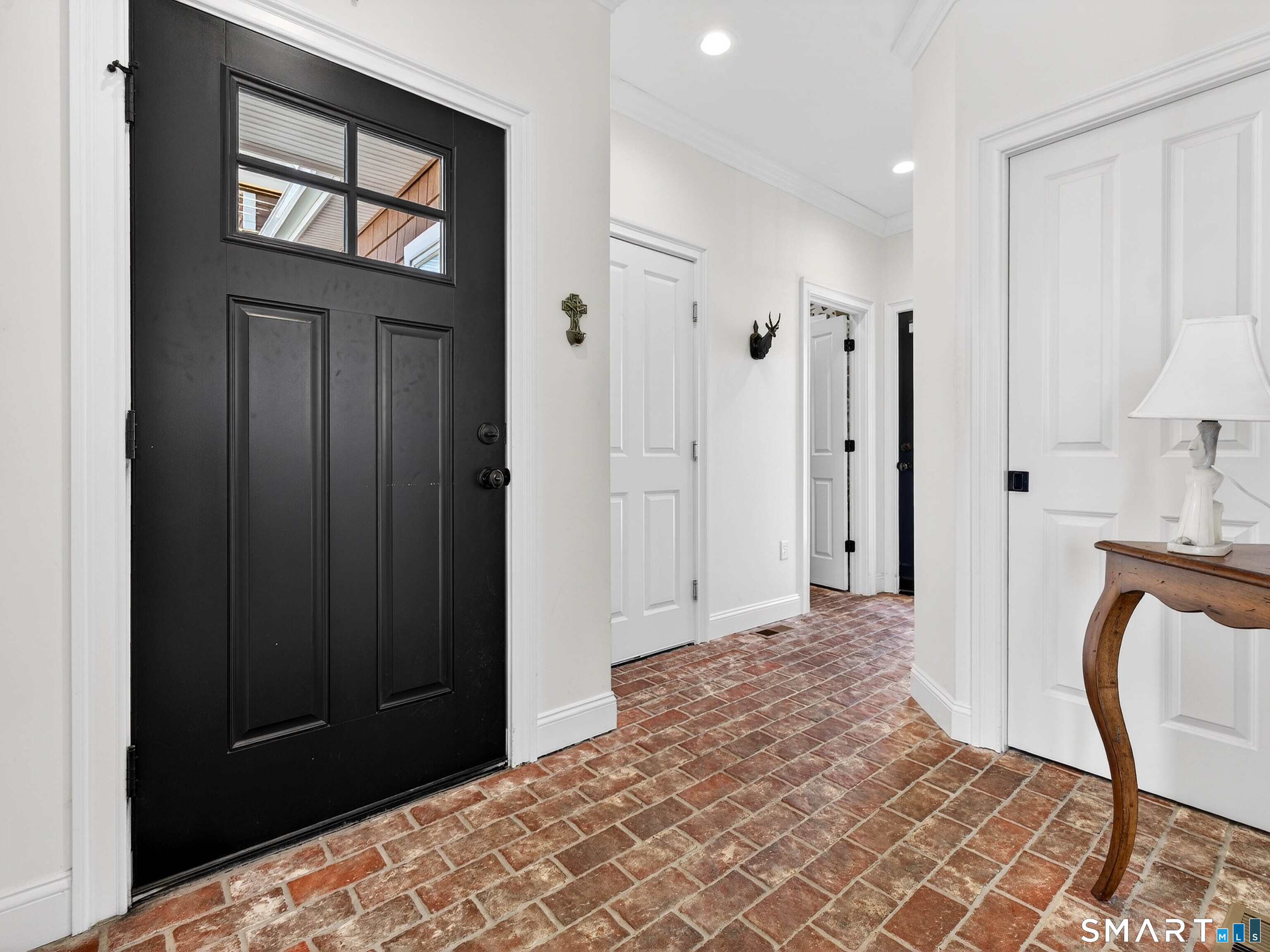 77 Masons Island Road Stonington, CT 06355 - Photo 3 of 35 a bedroom with a bed and a mirror