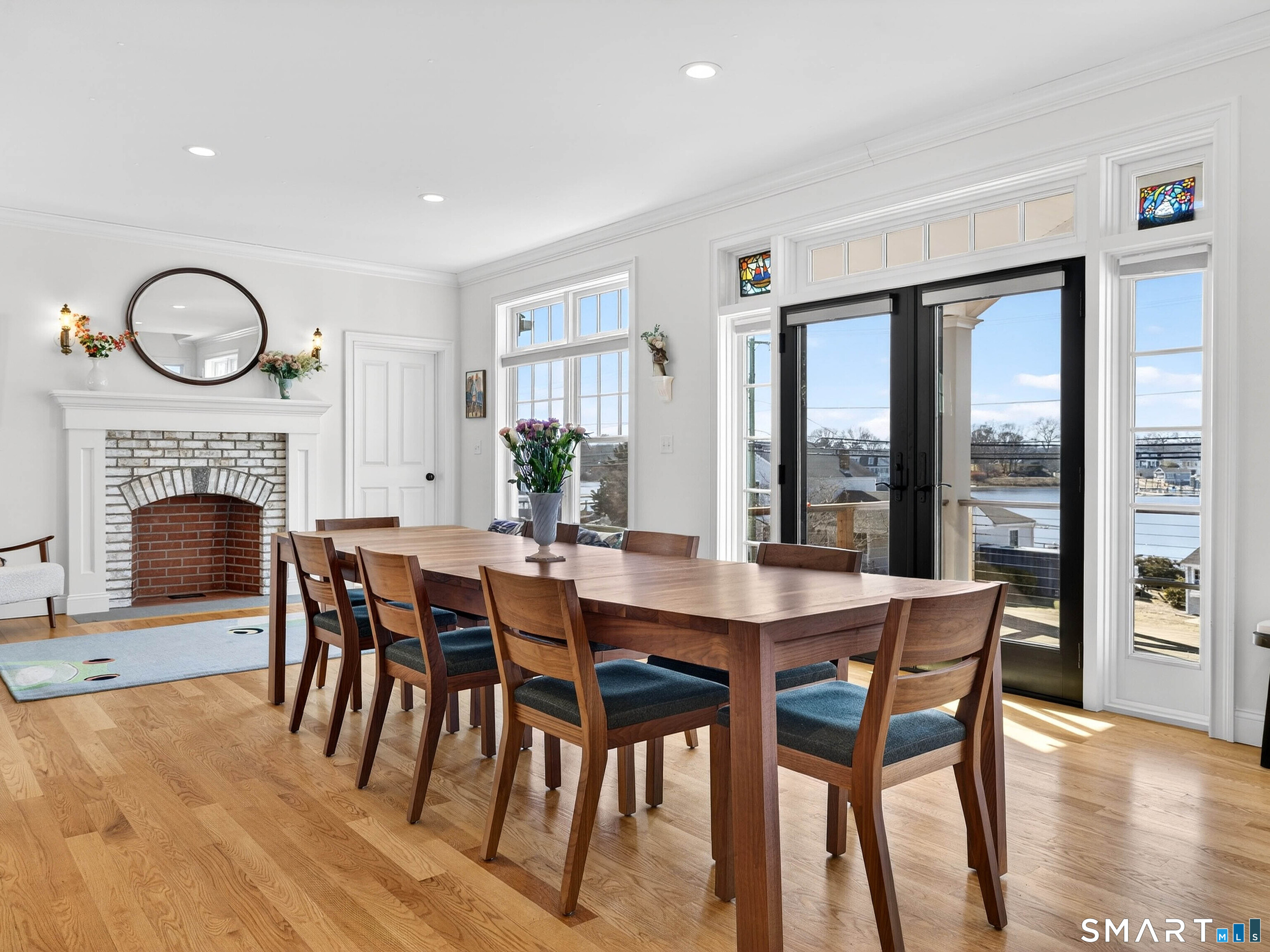 77 Masons Island Road Stonington, CT 06355 - Photo 5 of 35 a view of a dining room with furniture window and wooden floor