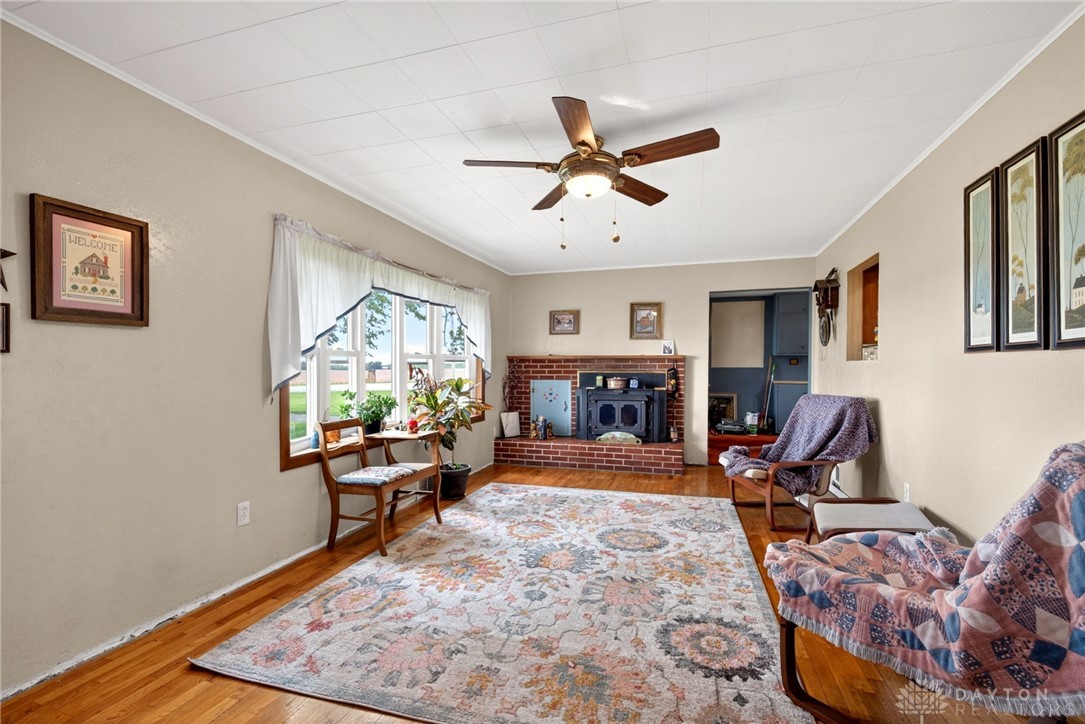 2470 Clark Run Road Xenia, OH 45385 - Photo 10 of 57 This inviting living space features hardwood floors and a cozy fireplace, perfect for relaxation.