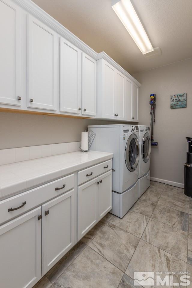 2129 Phaethon Lane Reno, NV 89521 - Photo 6 of 27 a utility room with cabinets washer and dryer