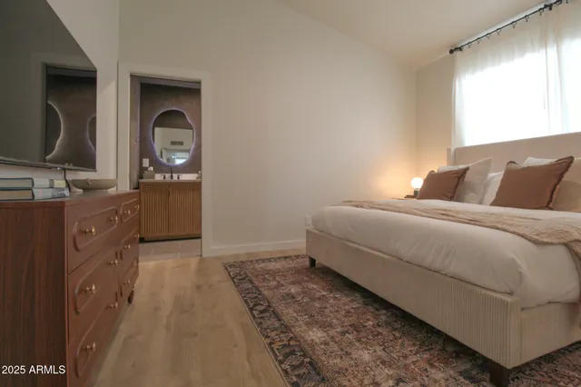 a bedroom with a bed and a table