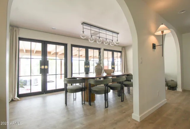 a bedroom with a large bed and a flat tv screen