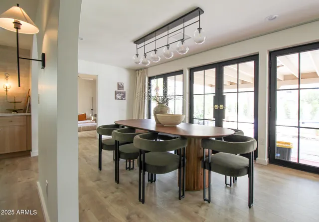 a bathroom with a granite countertop sink a mirror and shower