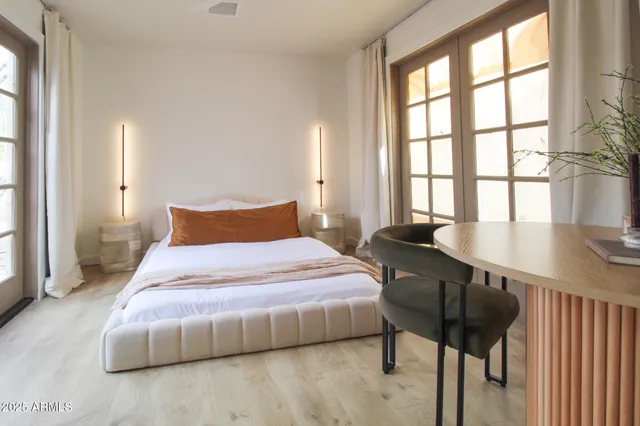 a bedroom with a bed window and flat screen tv
