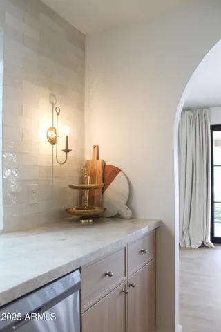 a kitchen with a sink and a stove top oven with wooden floor