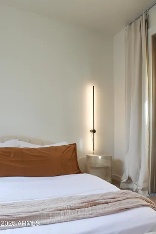 a living room with furniture a flat screen tv and a window