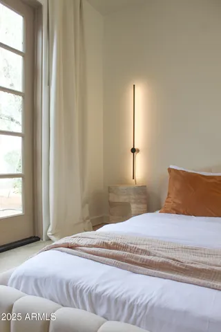 a living room with furniture a flat screen tv and a window
