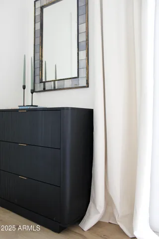 a living room with chairs and a flat screen tv