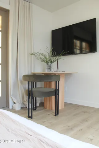 a bedroom with a bed and a large window