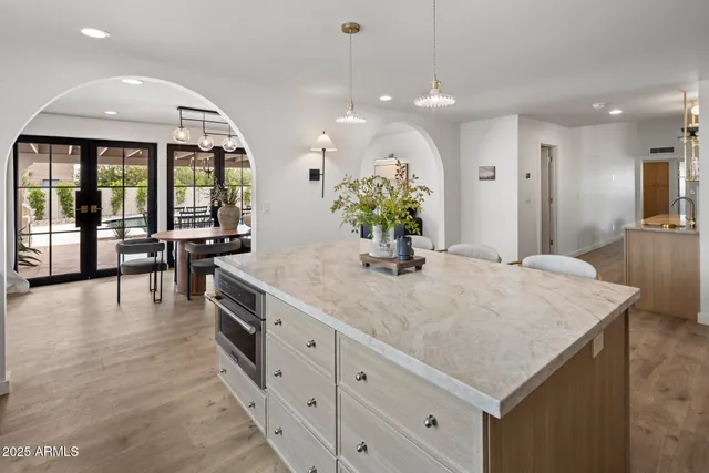 a living room with furniture a chandelier and a window