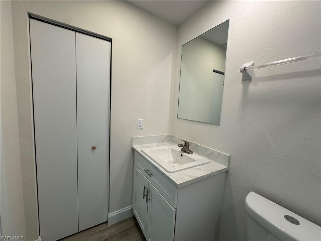 221 18th Avenue Northwest Naples, FL 34120 - Photo 11 of 22 a bathroom with a sink a toilet and shower