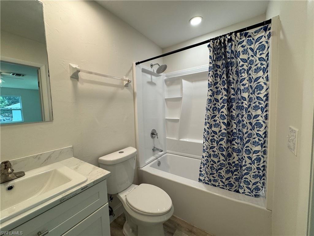 221 18th Avenue Northwest Naples, FL 34120 - Photo 12 of 22 a bathroom with a toilet a sink and a shower