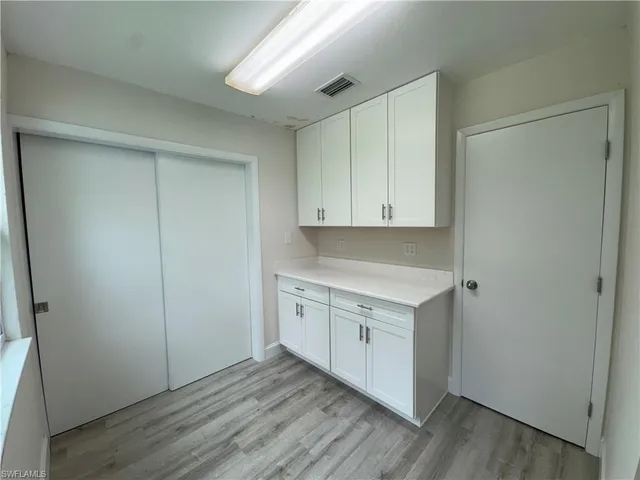 a bathroom with a granite countertop sink mirror vanity and toilet