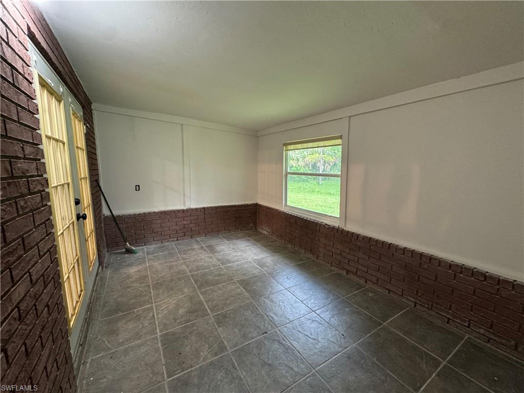 221 18th Avenue Northwest Naples, FL 34120 - Photo 20 of 22 an empty room with windows