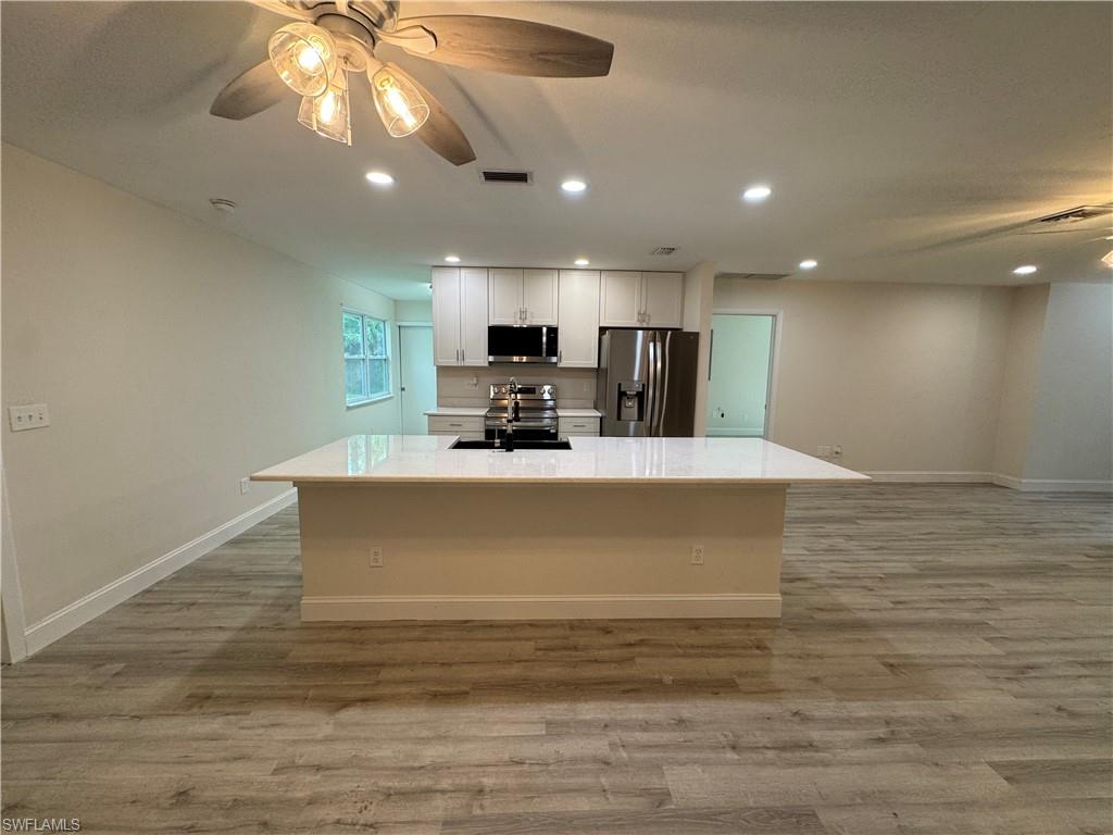 221 18th Avenue Northwest Naples, FL 34120 - Photo 2 of 22 a view of kitchen and microwave