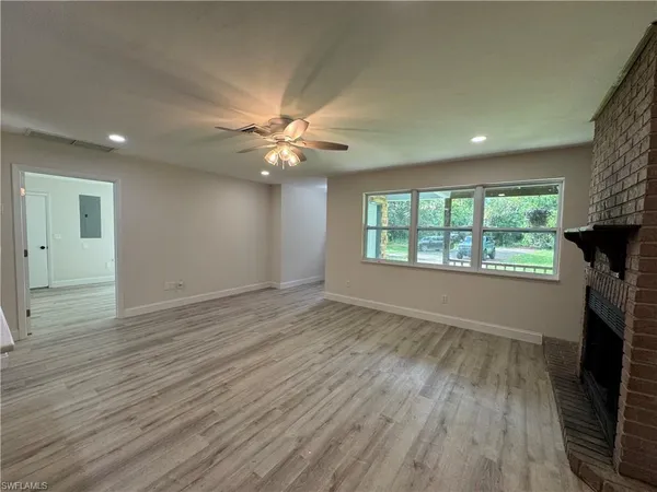 a kitchen with a sink appliances and a large window