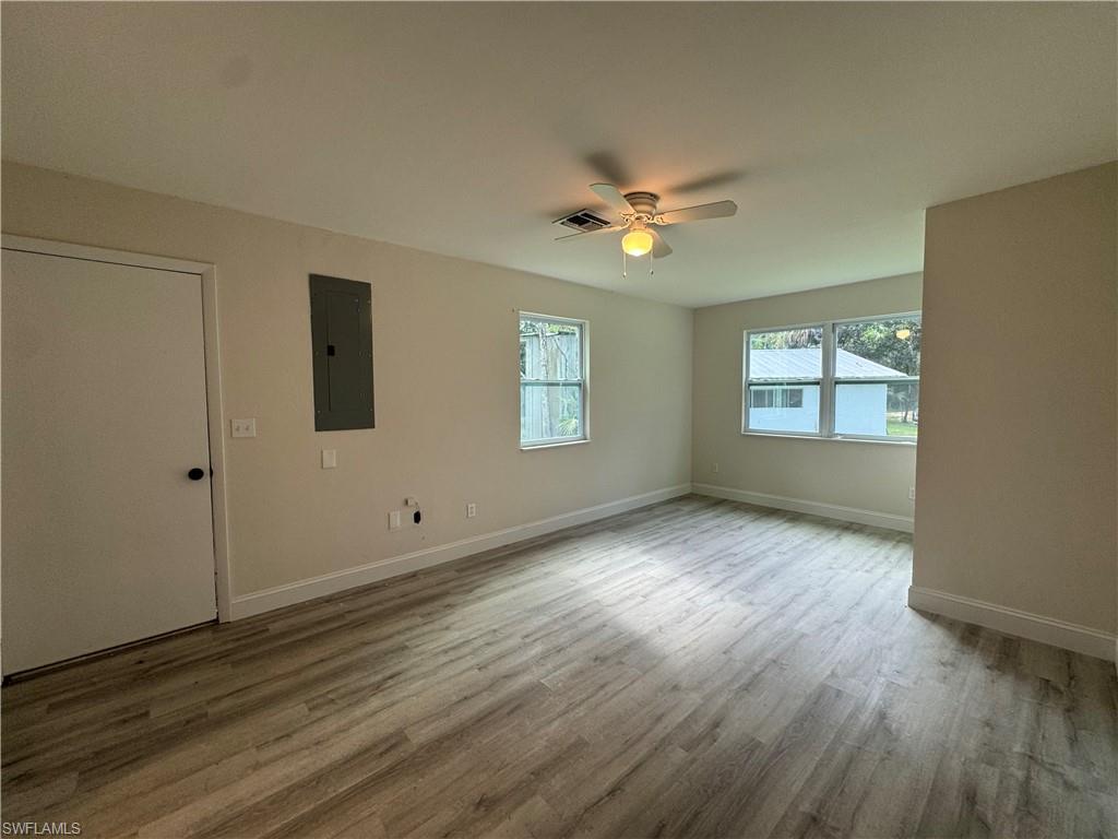 221 18th Avenue Northwest Naples, FL 34120 - Photo 9 of 22 a view of empty room with wooden floor and fan