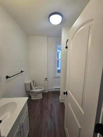 a bathroom with a sink a toilet and a tub