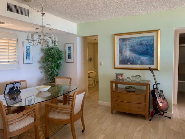 300 Ocean Trail Way, Unit 602 Jupiter, FL 33477 - Photo 2 of 17 a view of a dining room with furniture and wooden floor